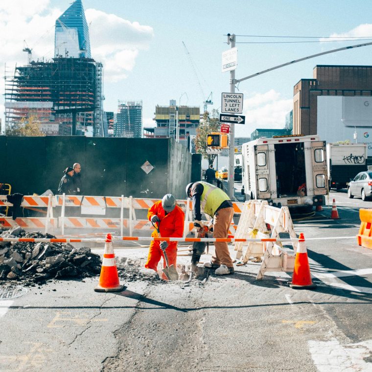 Busy construction site with workers wearing PPE to avoid workplace accidents